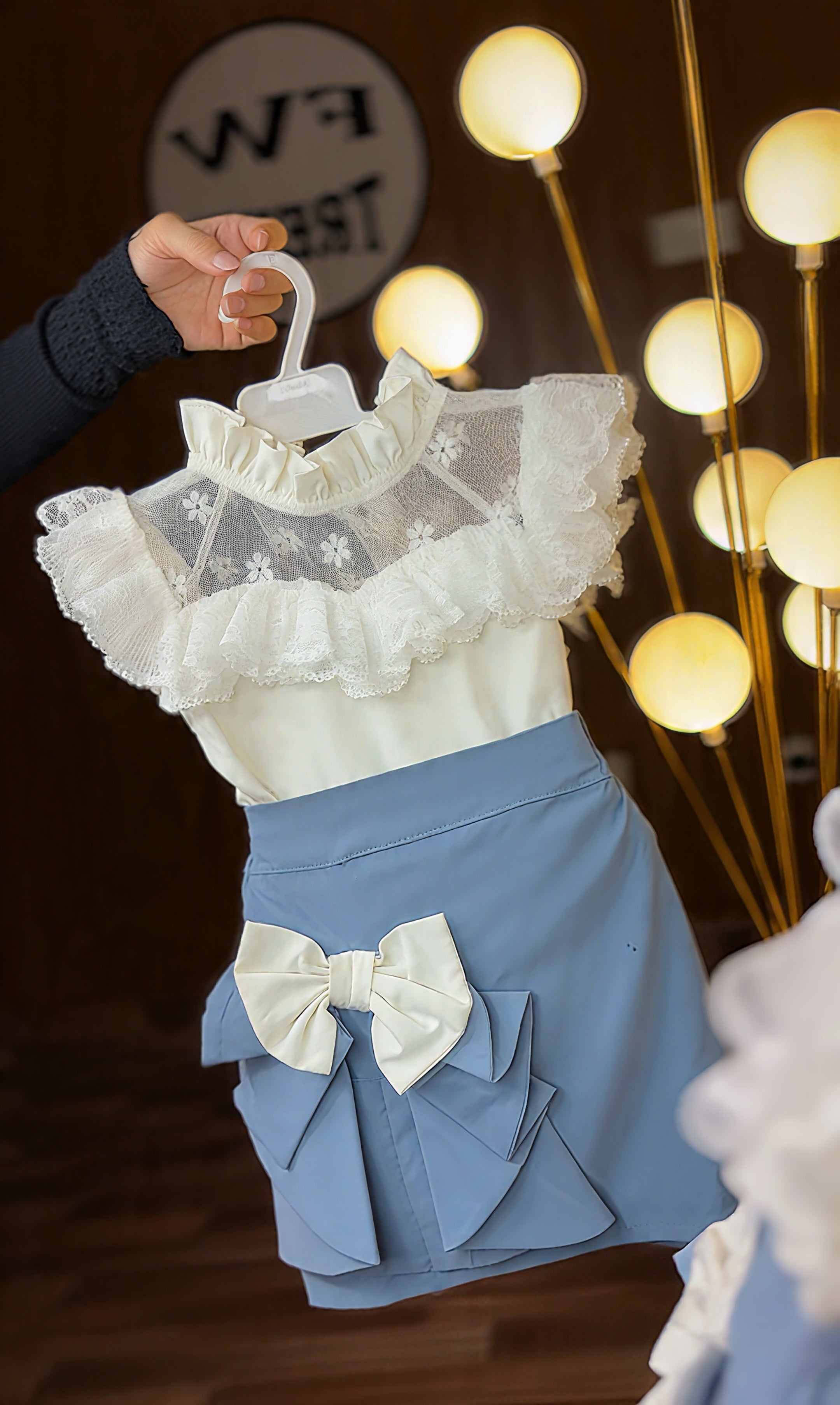 Frilly white top with blue skirt