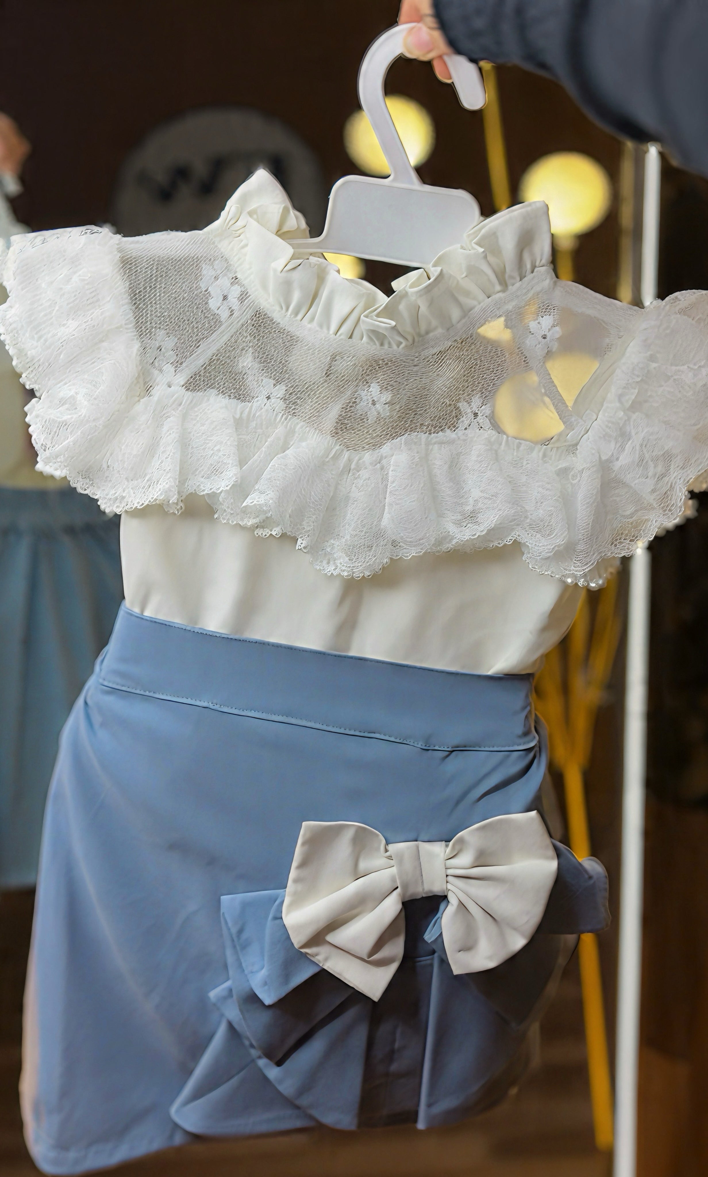 Frilly white top with blue skirt